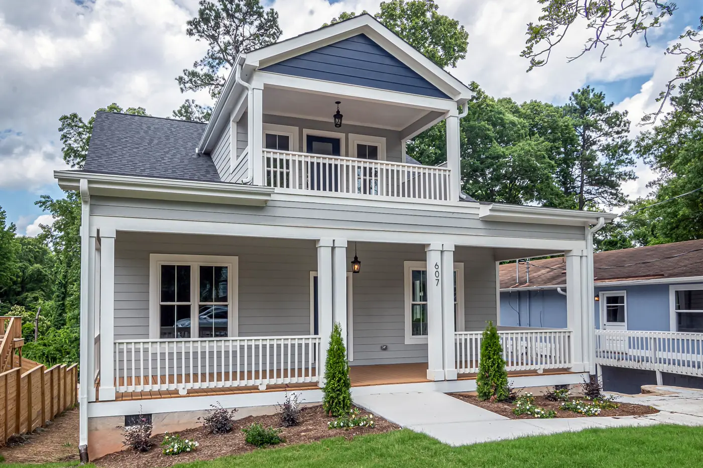 A new two-story home with a covered front porch and architectural shingle roof